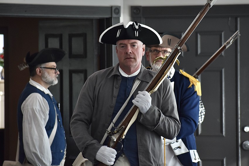 The Sons of the American Revolution march forward, led by Jeff Robbins.