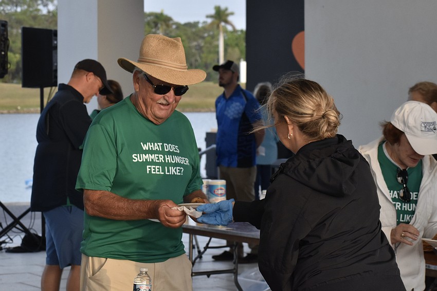 Norm Sharrit accepts a breakfast from Katy Balon of Pop's Sunset Grill.