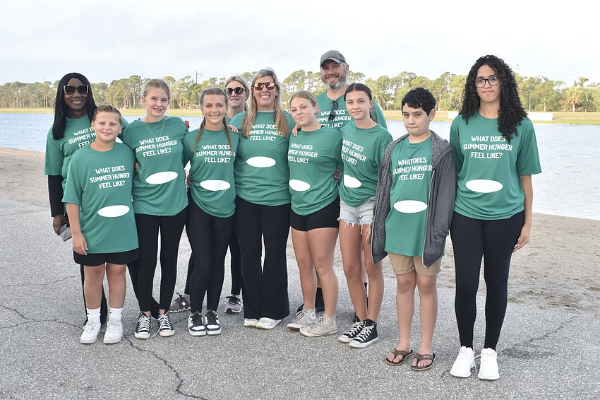 Students from Booker Middle School cut the ribbon and led the walk. Left to right: Principal LaShawn Frost, 8th graders Cooper Schaeffer, Isabella Shugerman and Izabella Shaffer, Alexis Pitche, Haley Shaffer, eigth grader Piper Fanchur, Chad Schaeffer, and eighth graders Picci Johnson, Allen Schaeffer and Laura Viamonte.