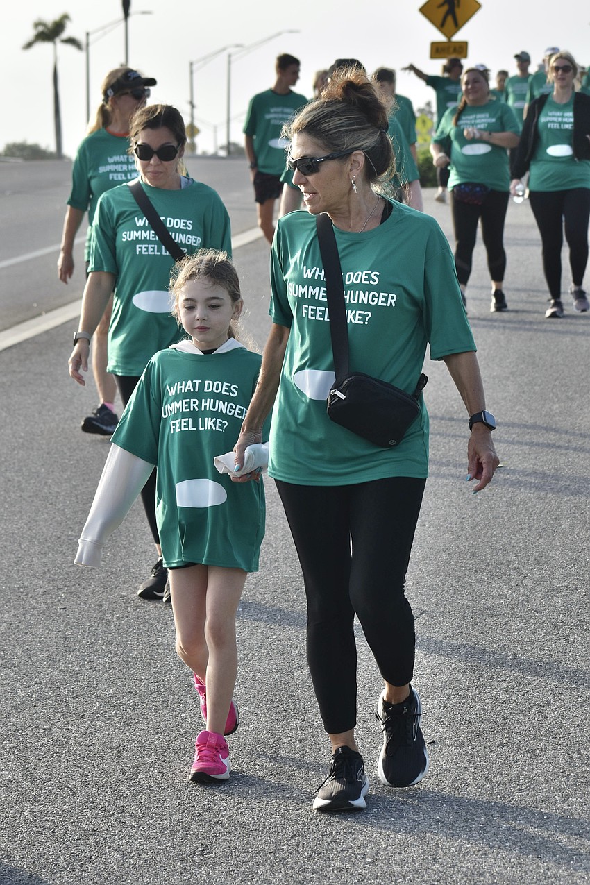 Addison Kibel, 9, and her grandmother Diane Crawford, walk together.