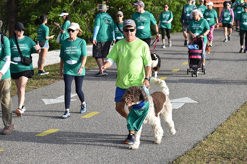 Charles Swigard walks with his dog Beau.