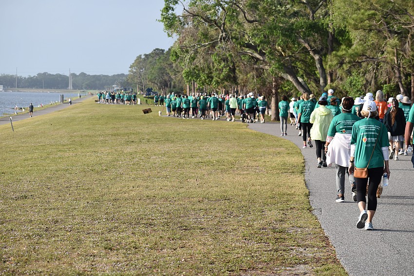 Participants in the walk head down the path at Nathan Benderson Park.