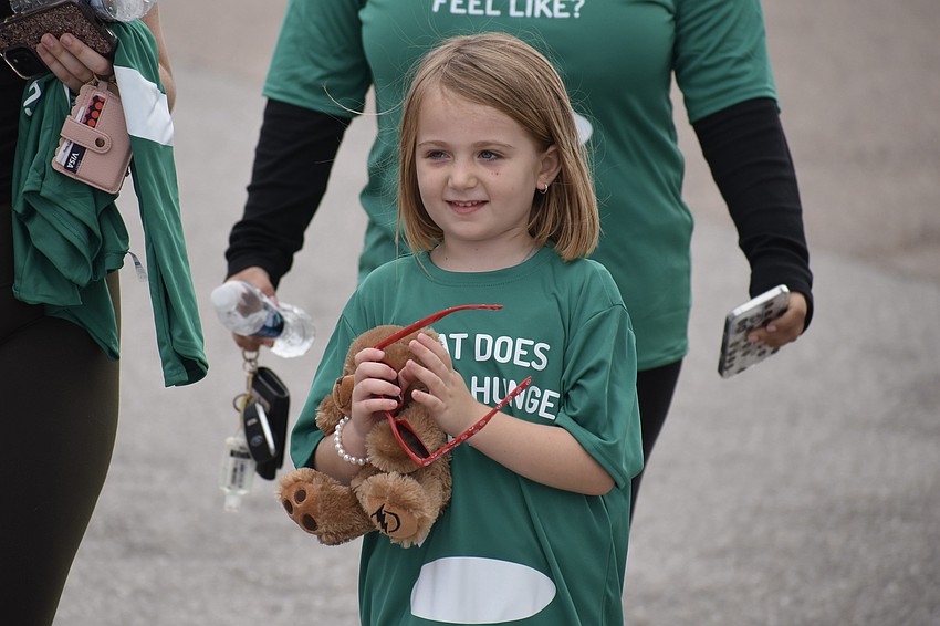 Cameron Plehn, 6, finishes the walk, on which she took along her stuffed bear Lightning, who came from a Tampa Bay Lightning game.