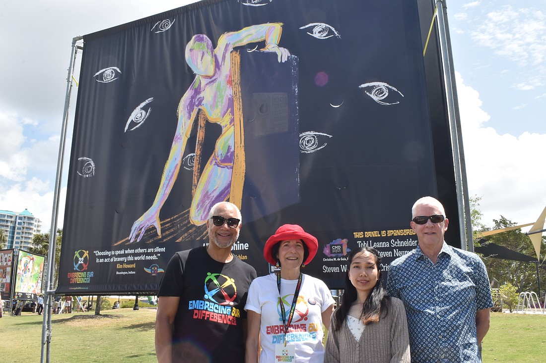 Allen Brown of Embracing Our Differences, Chantima Kaewvichian of Bangok, Thailand, the painter of "Hide or Shine," and its sponsors Tobi Leanna Schneider and Steven Neumeister, gather in front of the art piece. The quote by Kim Howard of Bloomington, Indiana, reads, "Choosing to speak when others are silent is an act of bravery this world needs."

"My inspiration for this painting is so simple. It's the feeling to be ourselves, like everybody deserves to be themselves, as long as it doesn't hurt anyone," Kaewvichian said. 

"I'm very happy, and I'm honored to be the part of this amazing exhibition," she also said.