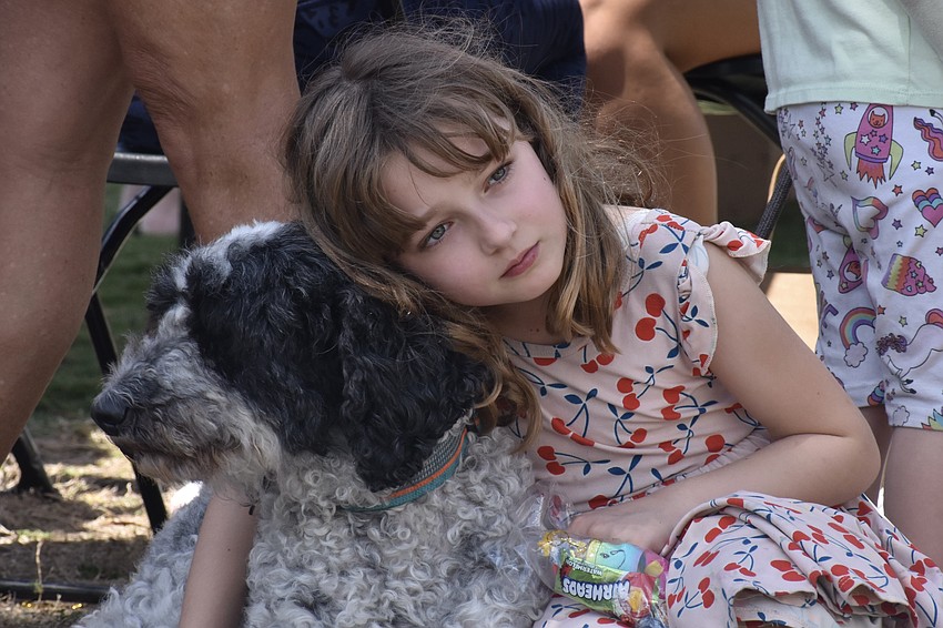 It was a hot afternoon, and Penny Lesnick, 7, takes a rest on Oreo.