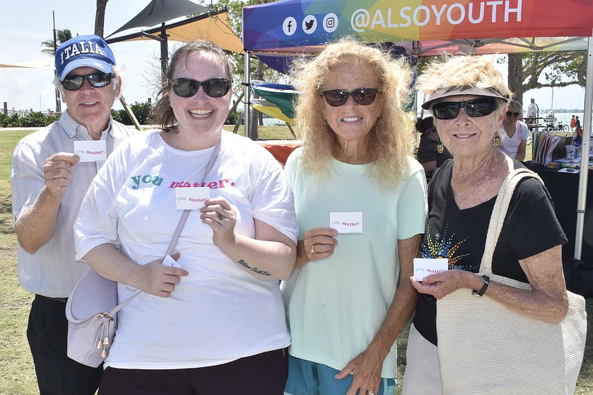 Tim O'Brien, Rachel Denton of Gulf Coast Community Foundation, Deb Benson and Tim's wife Deb O'Brien hold the foundation's 