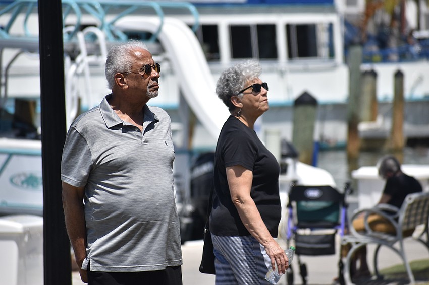 Paul Toliver and his wife Jane Toliver look at the artwork.