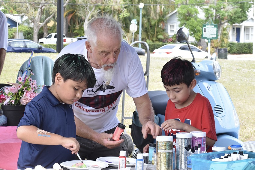 Abraham Evaristo, 6, Bonnie Cruchfeld and Jayvion Robinson, 9, work on an craft project.