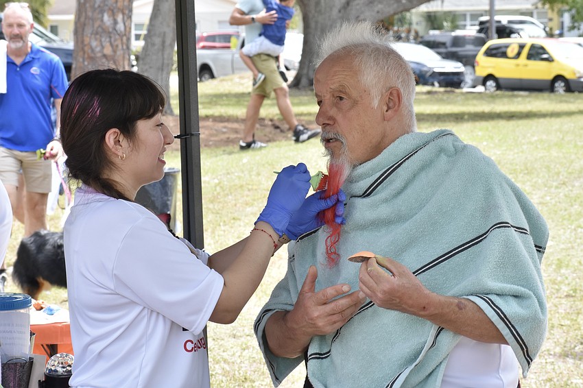 Brittany Gomez dyes the beard of Bonnie Cruchfeld.