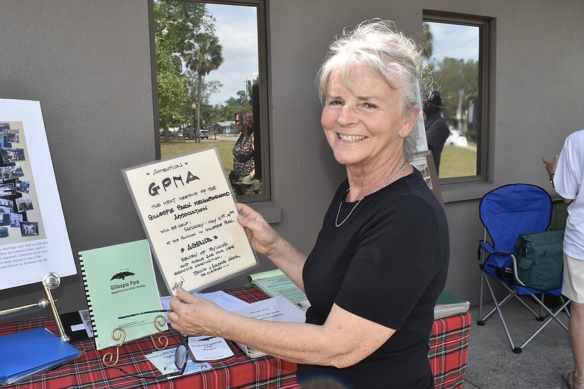 Beverly Scott holds a notice for a meeting of the Gillespie Park Neighborhood Associaiton from the year of its founding in 1983.