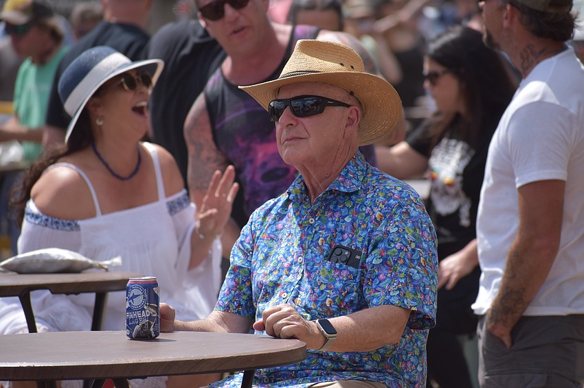 Jeff Hoffman relaxes at a table as he listens to the music.