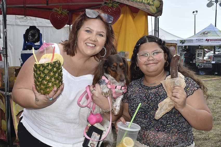Caitlyn Florrow, her dog Sunny and her daughter Leila Florrow, 12, bought some tropical refreshments.