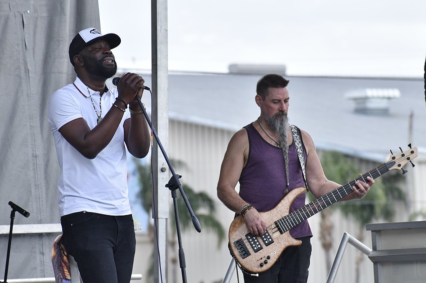 King Tappa and Brett Sharbaugh perform on stage.
