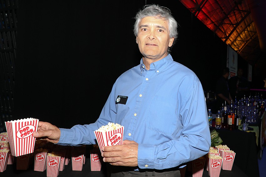 Save Our Seabirds office manager Alex Torres passes the popcorn as guests arrive to the annual gala.