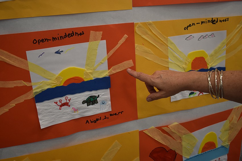 Art teacher Gina Gretz explains that her second grade students used different materials such as tissue paper, felt and markers to create sunsets and sea creatures.