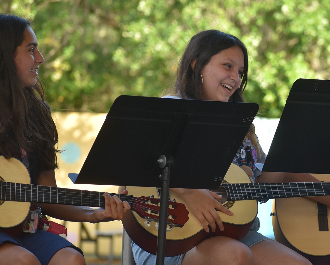 Alexandra Gutierrez and Aliah Reyes enjoy a break between songs during their performance.