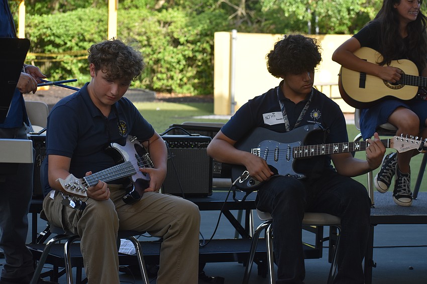 Connor Bassett and Ramses Carmona play both acoustic and electric guitars during their performance.