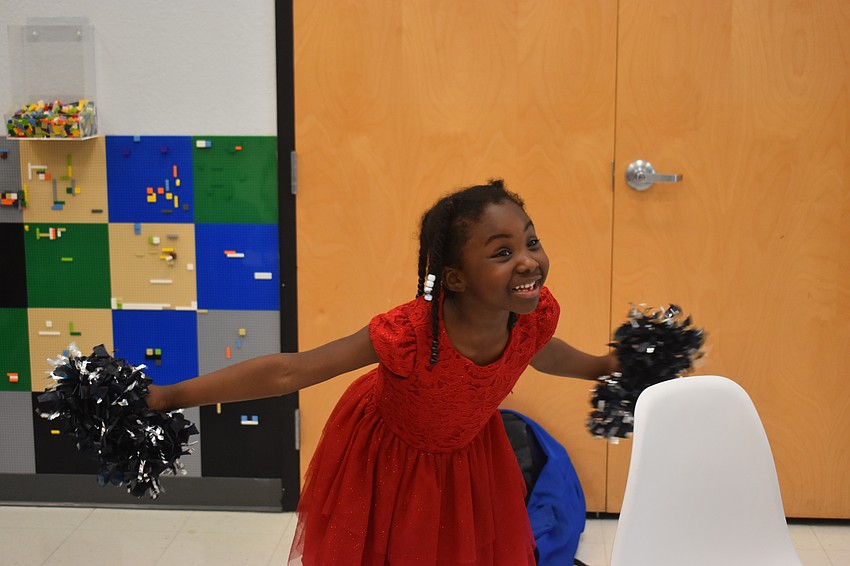 First grader Mya Branch performs a cheer for her sister Joy Branch, who is in second grade.