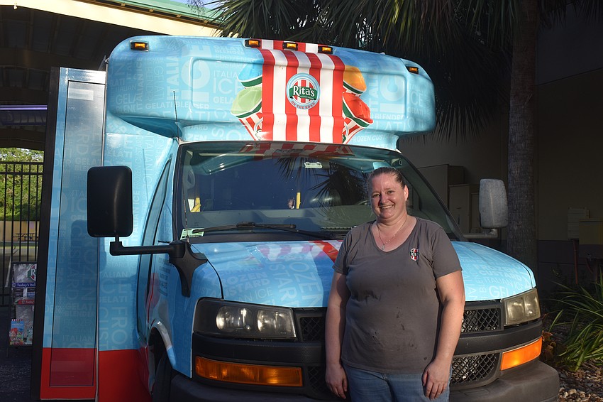 Kelsey Wright, owner of Rita's Italian Ice & Frozen Custard, takes a break in front of her food truck after being busy at the Imagine School at Lakewood Ranch event.