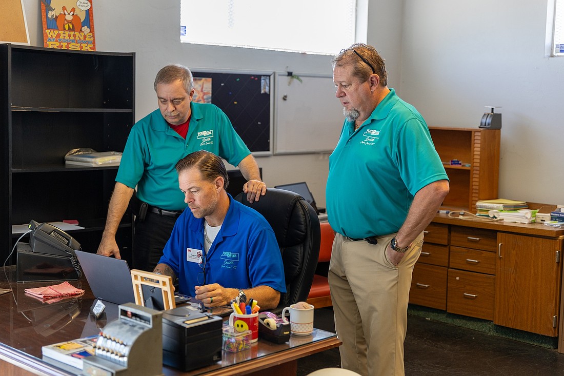 From left to right, Don Wagner, Travis Prince and Forbes Snyder owner Paul K. (PK) Backholm, working in the company's Fort Myers office.