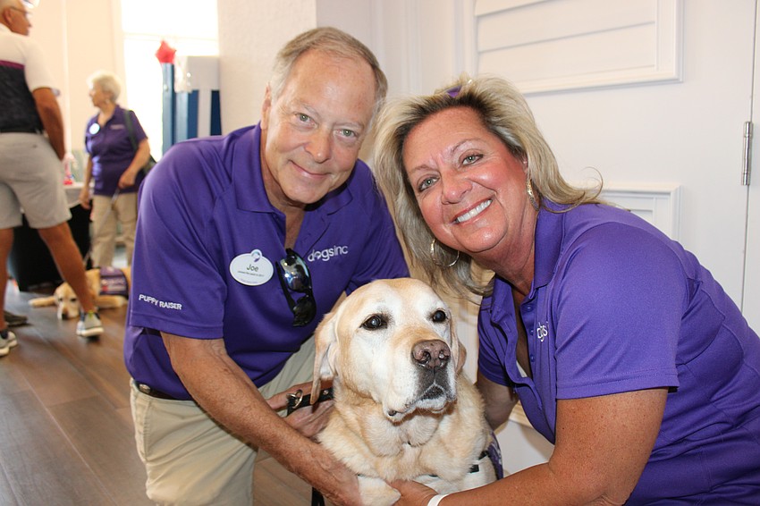 Parrish's Joe and Vicky Cox, who are puppy raisers for Dogs, Inc., show off Keni, a retired guide dog, at the Rosedale Golf Classic April 2.