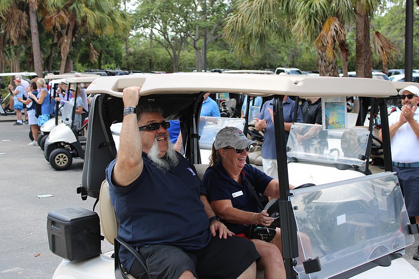 Army Sgt. Aaron Cornelius, who was blinded by an IED blast in Iraq in 2008, arrives during a brief parade before the 2025 Rosedale Golf Classic April 6. Dianne Travers of Homes for Our Troops drives the cart.