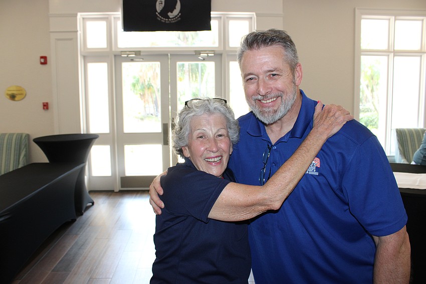 Rosedale Golf Classic co-founder Deb Kehoe gets a hug from 2023 honoree Christopher Blauvelt, a career solder, before the 2025 event on April 2.