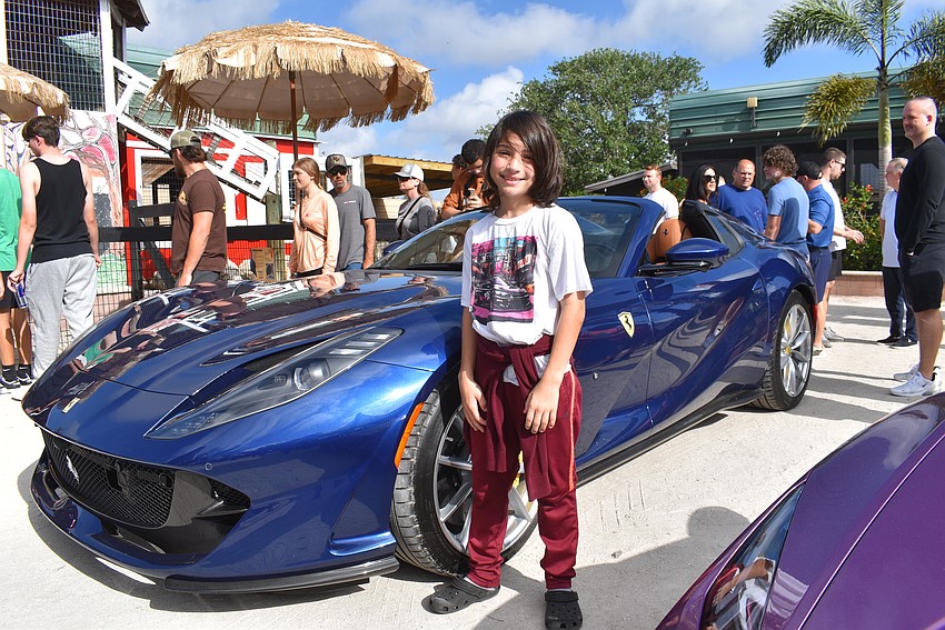 Sarasota's 9-year-old Sage DeMars loves cars, and his brother loves animals. Mom Brittany DeMars says Cars and Coffee Gone Wild is the perfect mix.