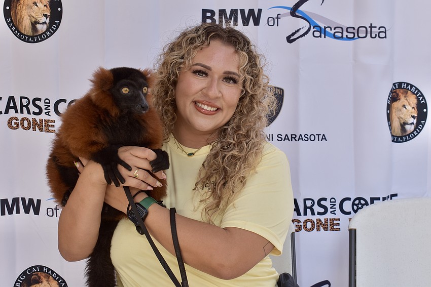 Jazlyn Ocampo, project manager at Big Cat Habitat, holds Toby, a 2-year-old red ruffed lemur.