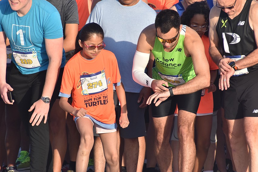 Michelle Lugo, 9, and Sebastian Kovendy await the start of the 5K.
