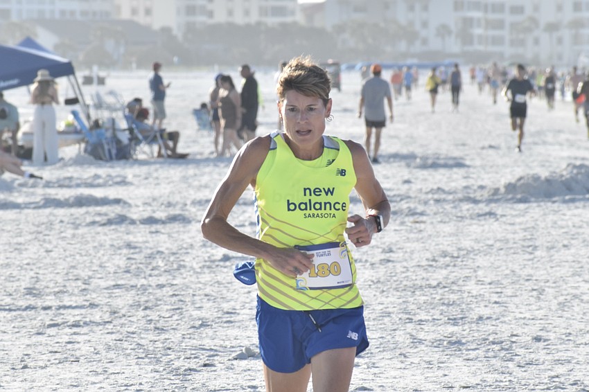 Heather Butcher, the top overall female, finishes the race.