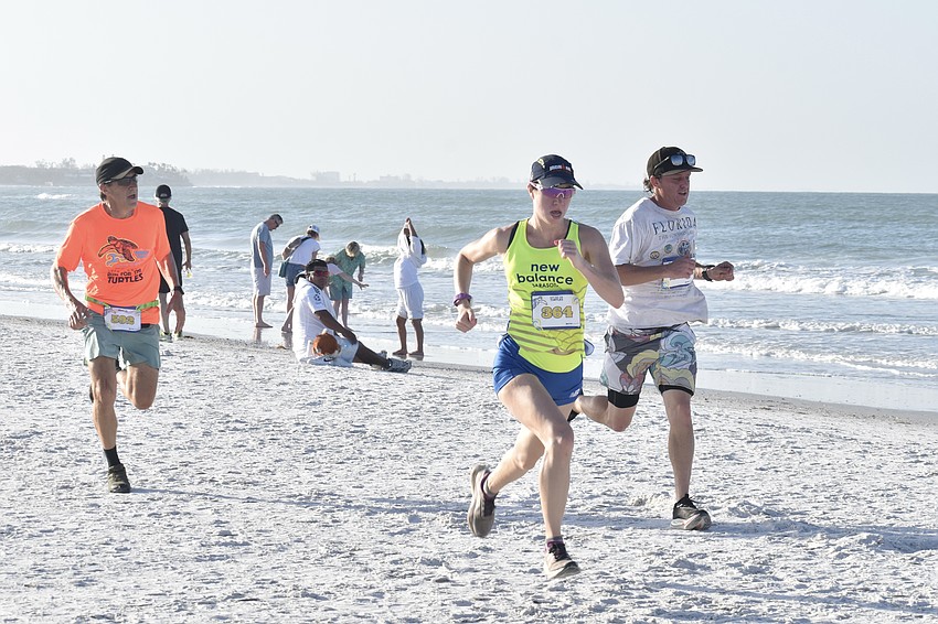 Roger Janczak, Hannah Chupp and Erik Wydner head for the finish line.