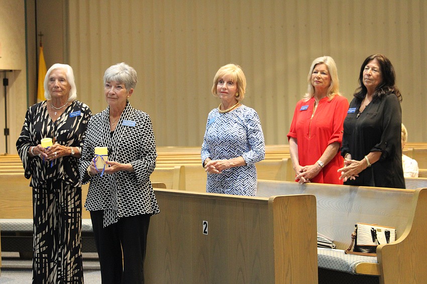 From left, Marilyn Davol, Mary Del Pup, Susan Gilmore Clarke, Kay Kochenderfer and Lynn Kennelly swear to uphold their duties as the officers of the Women's Guild at St. Mary, Star of the Sea, Catholic Church.