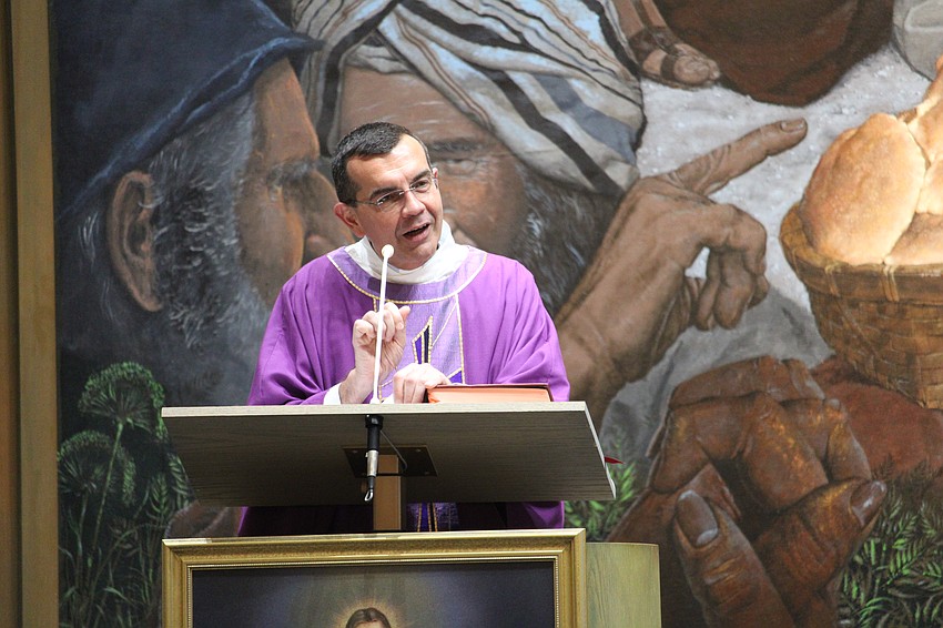 Father Robert Dziedziak explains the importance of the guild's work during an installation service.