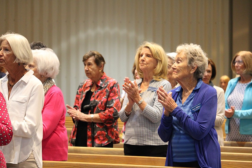 Women's Guild members including Janet Milliken applaud the installation of the officers.