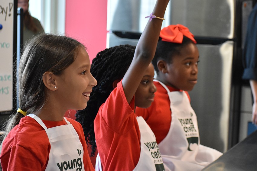 Ryker, a fourth grader, and third graders Mahogany and Mia listen to a discussion.