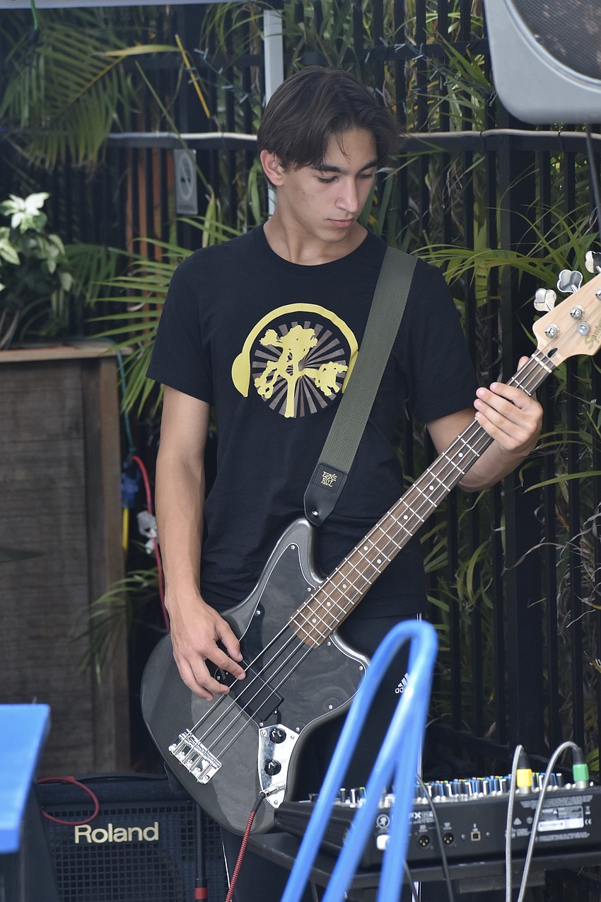 Chase Scott, 15, of Music Compound, performs at the market.