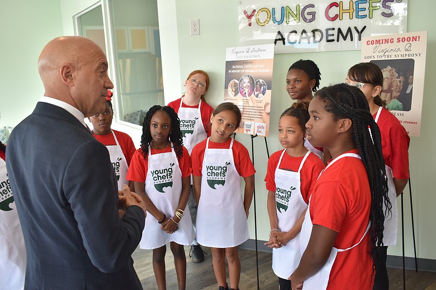 Bill Villafranco, trustee of the Virginia B Toulmin Foundation, speaks to the girls, telling them about the accomplishments of Virginia B Toulmin.