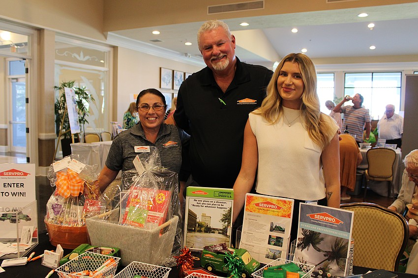 Servpro's Debbie Shaffer, Paul Schott and Sierra Nunn educate attendees on the services they offer, particularly for treating stormwater damage.