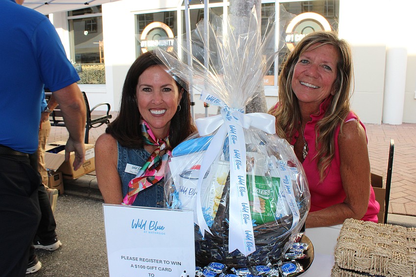 Dee DelFabro and Victoria White of Stock Development tell those attending the Block Party and Club Day about the new Wild Blue neighborhood.
