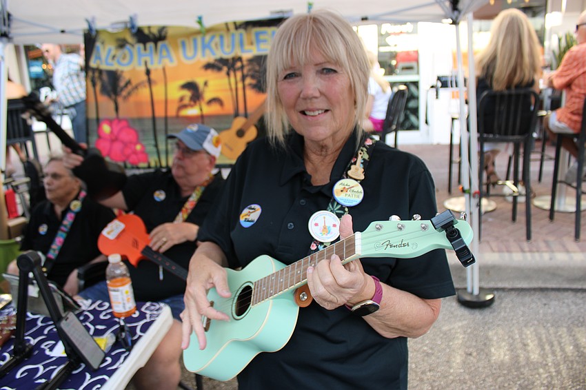 Pattie Bell strums a tune as a member of Aloha Ukulele of Lakewood Ranch during the Block Party and Club Day.