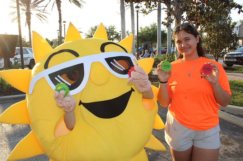 Mirav Steckel, a unit head counselor for Camp Yonnie, gets a little help promoting The Jewish Federation camp during the Block Party and Club Day.