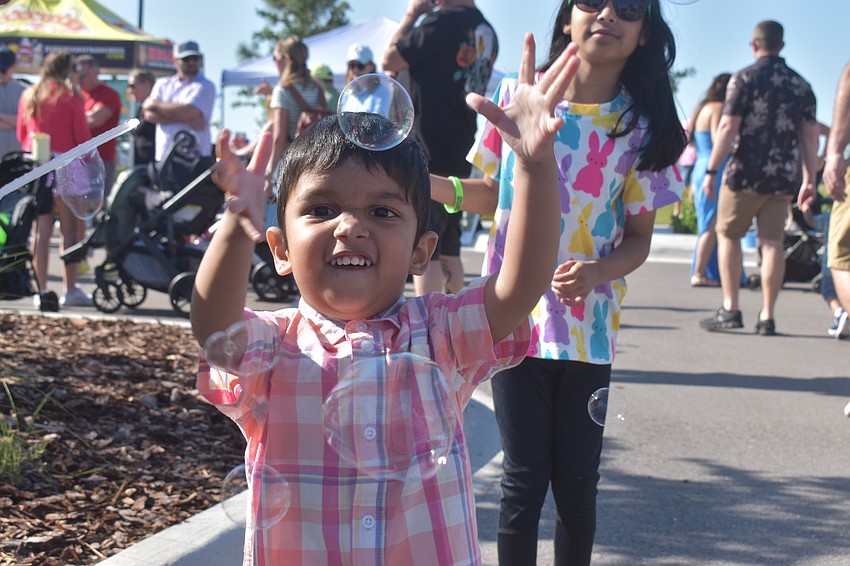 Who needs eggs when you have bubbles? Elio Maharaj, 3, chases bubbles through Waterside Park during Eggstravaganza.