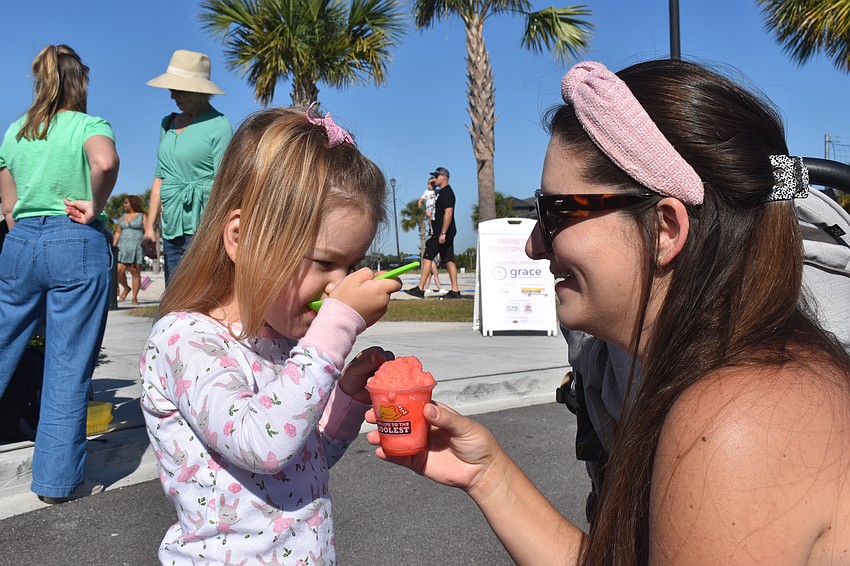 Ava Miller, 2, enjoys a strawberry lemonade flavored treat with her mom, Alissa Miller.