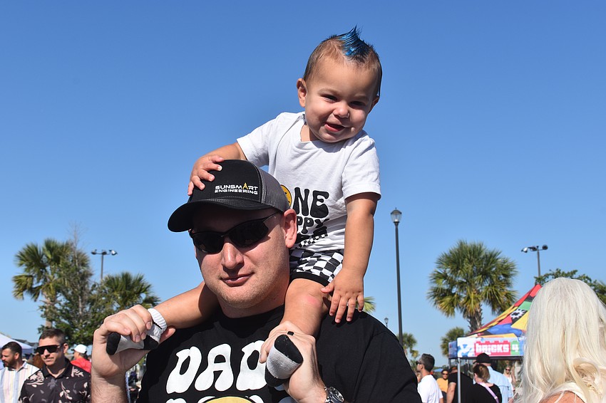 Troy Phelan gives his 1-year-old Kash a ride during Eggstravaganza.