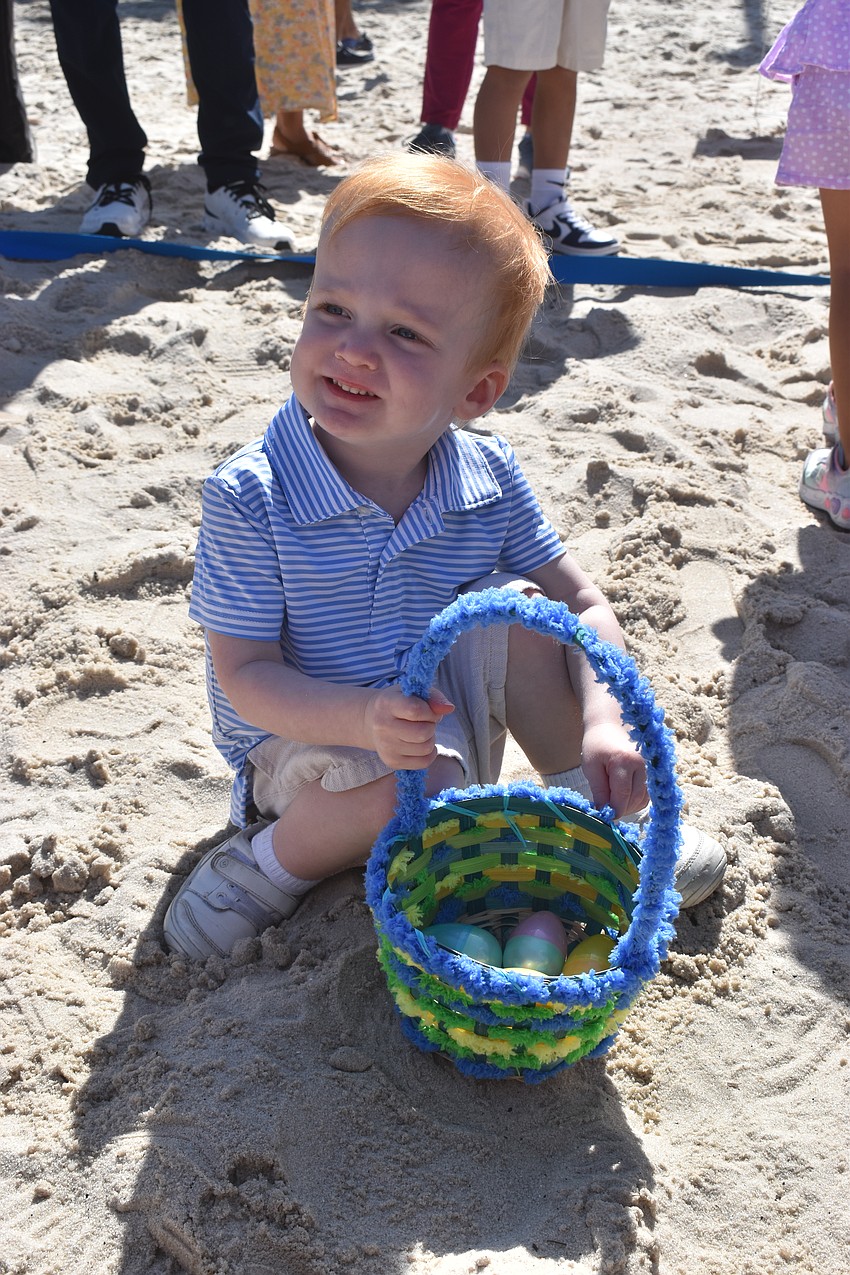 Jay Marsh, 2, fills his basket during Eggstravaganza.