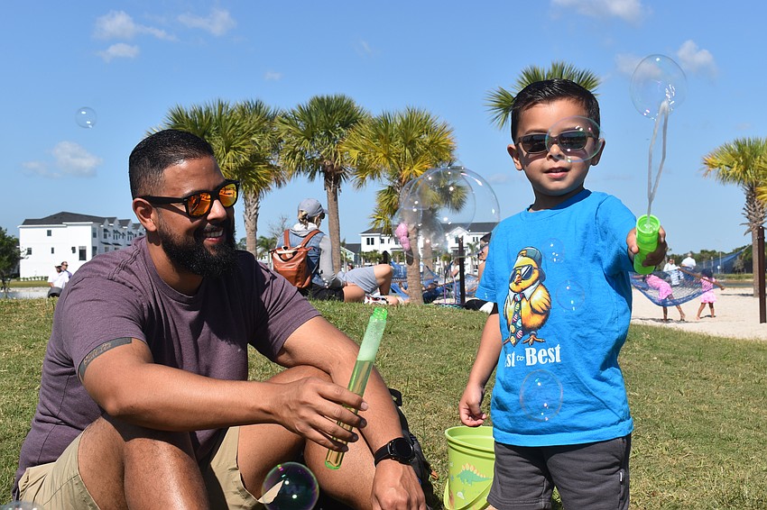 Cesar Levison and 3-year-old Roman Levison search for the perfect bubble.