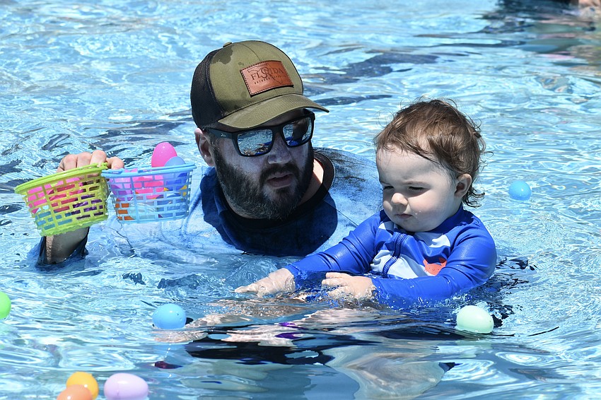Ben Morris and his son William Morris, 1, hunt for eggs.