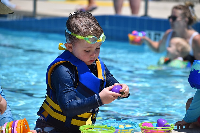Wyatt Morris, 3, looks over his findings.