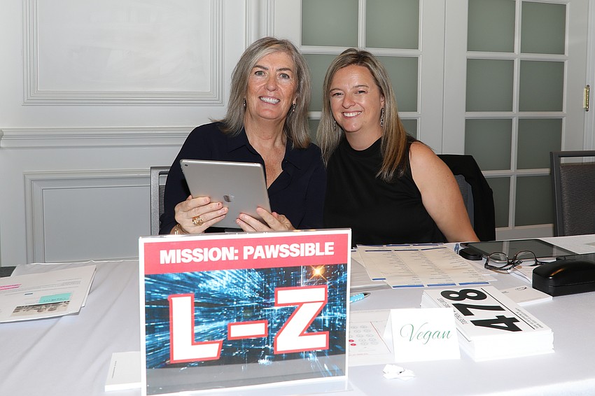 Volunteers Elaine Edging and Rebecca Coles check in some 300 guests at the Mission Pawssible event held for the Humane Society of Sarasota County.